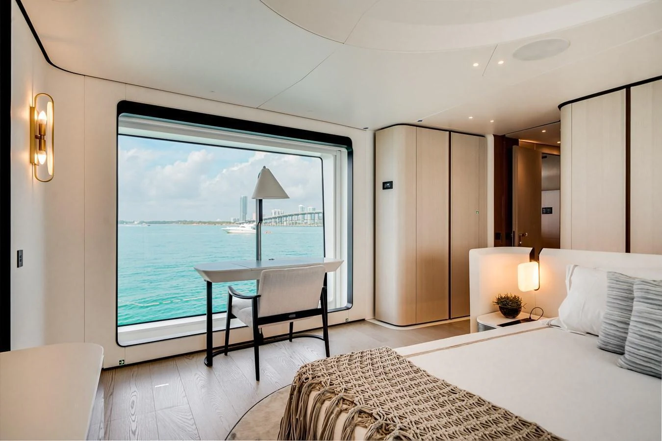 A luxurious stateroom with a large window offering a stunning ocean view. aboard TYCOON Yacht for Sale