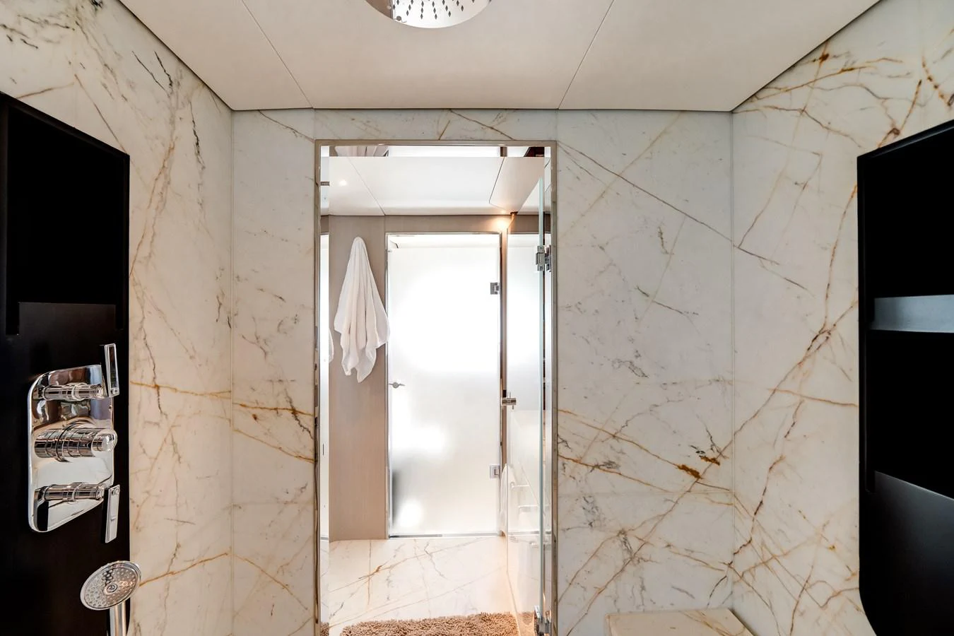 The yacht's bathroom features luxurious marble walls and modern fixtures. aboard TYCOON Yacht for Sale