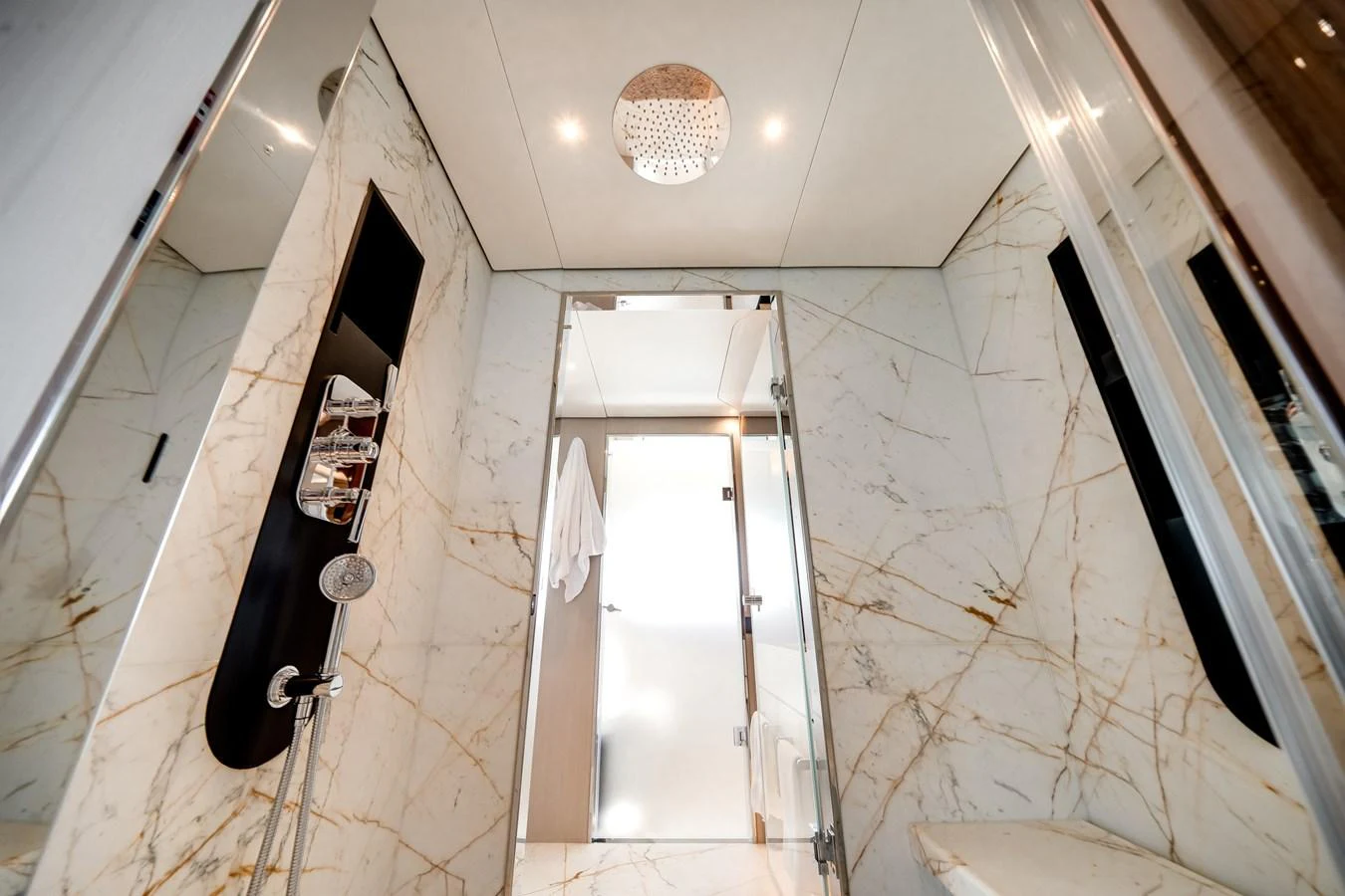 The yacht's bathroom features luxurious marble walls and modern fixtures. aboard TYCOON Yacht for Sale