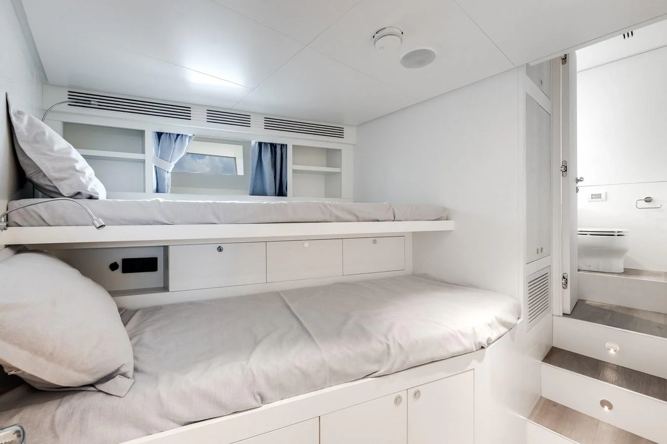 The crew quarters feature practical bunk beds with ample storage and a clean, modern design. aboard TYCOON Yacht for Sale