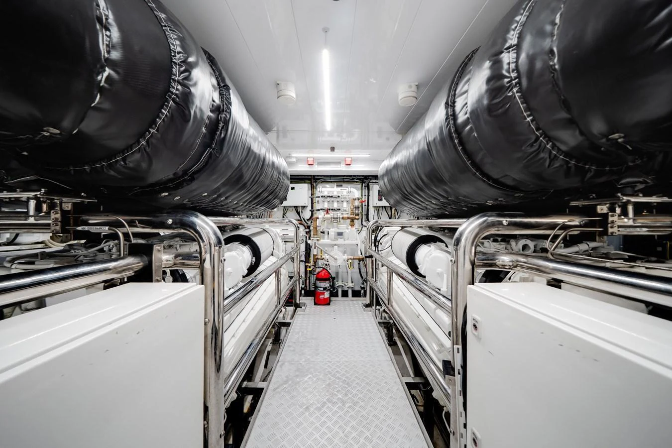 The yacht's engine room is meticulously organized, showcasing powerful machinery and pristine maintenance. aboard TYCOON Yacht for Sale