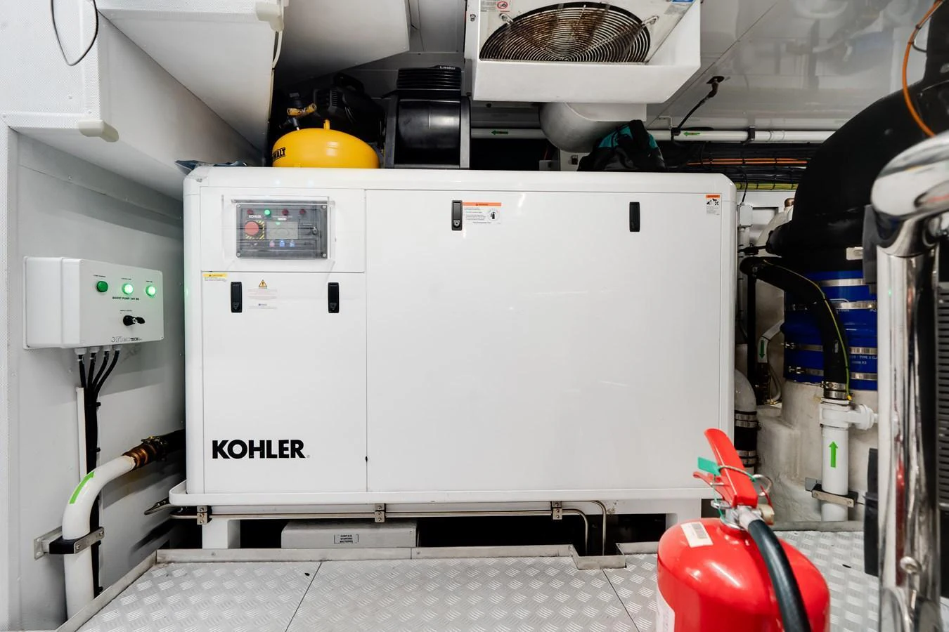 The image showcases the yacht's engine room with a Kohler generator and various equipment. aboard TYCOON Yacht for Sale