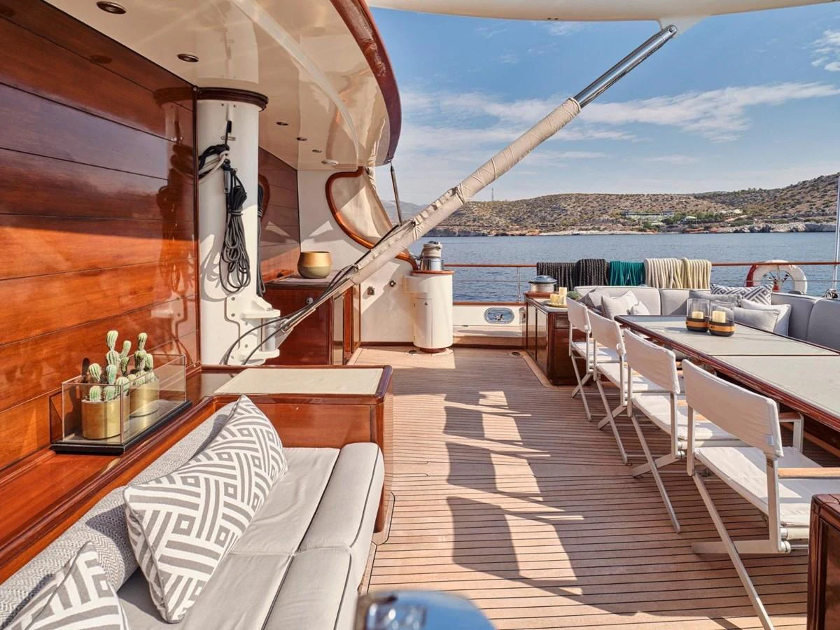 a restaurant with a view of the ocean and mountains aboard PASA Yacht for Sale