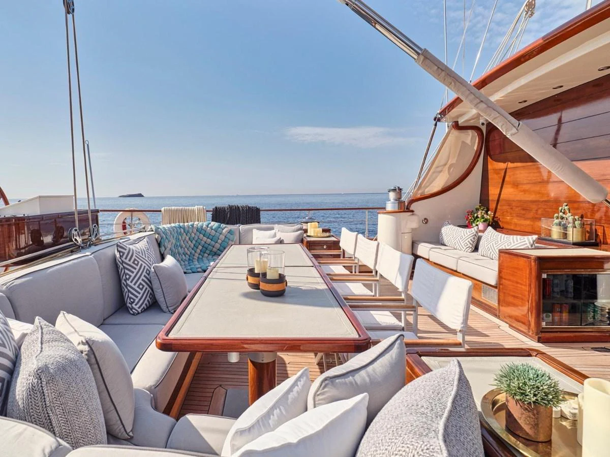 a patio with a table and chairs aboard PASA Yacht for Sale