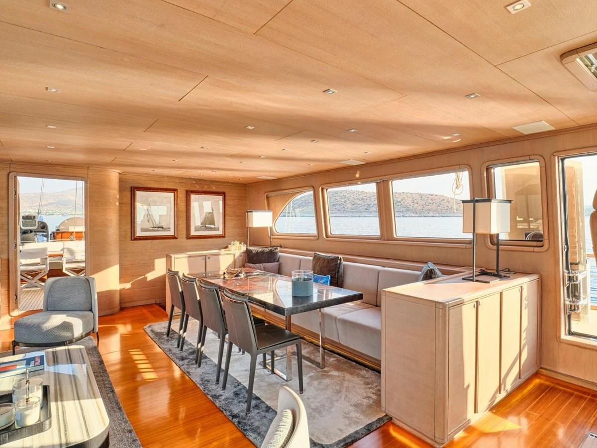 a living room with a couch and a table aboard PASA Yacht for Sale