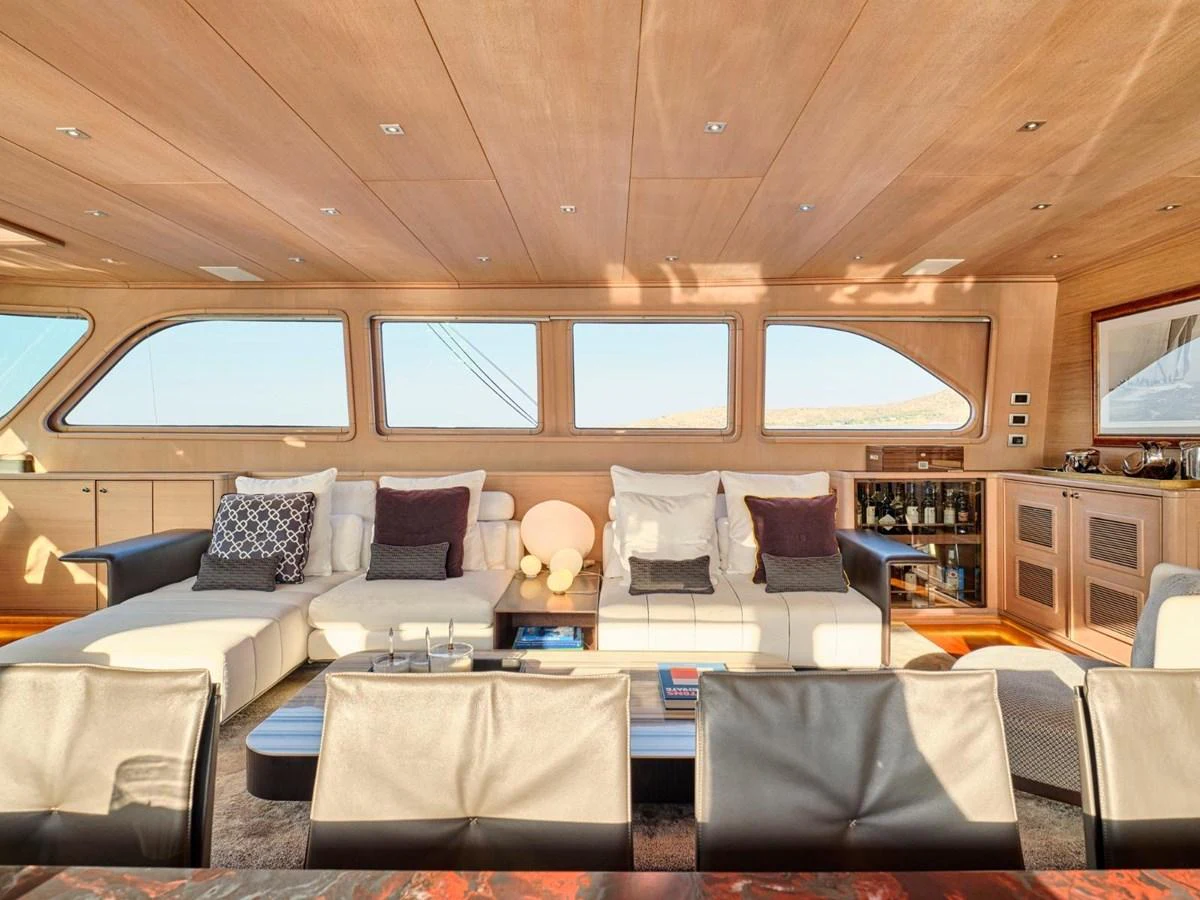 a living room with a couch and a tv aboard PASA Yacht for Sale