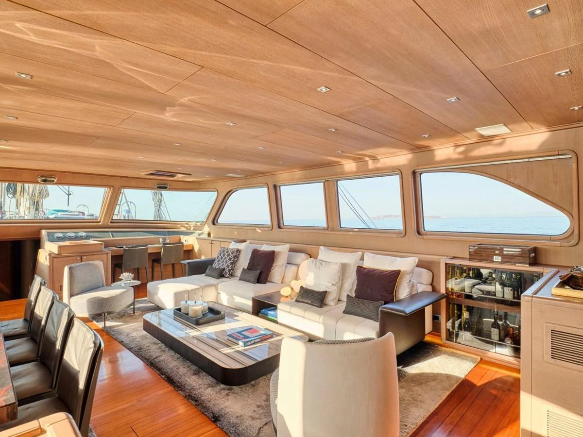 a room with a couch and a table and chairs aboard PASA Yacht for Sale