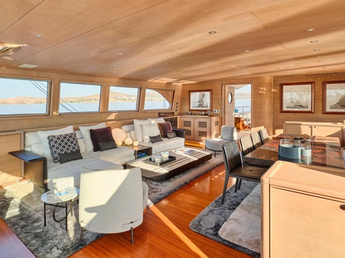 a living room with a couch and a table aboard PASA Yacht for Sale