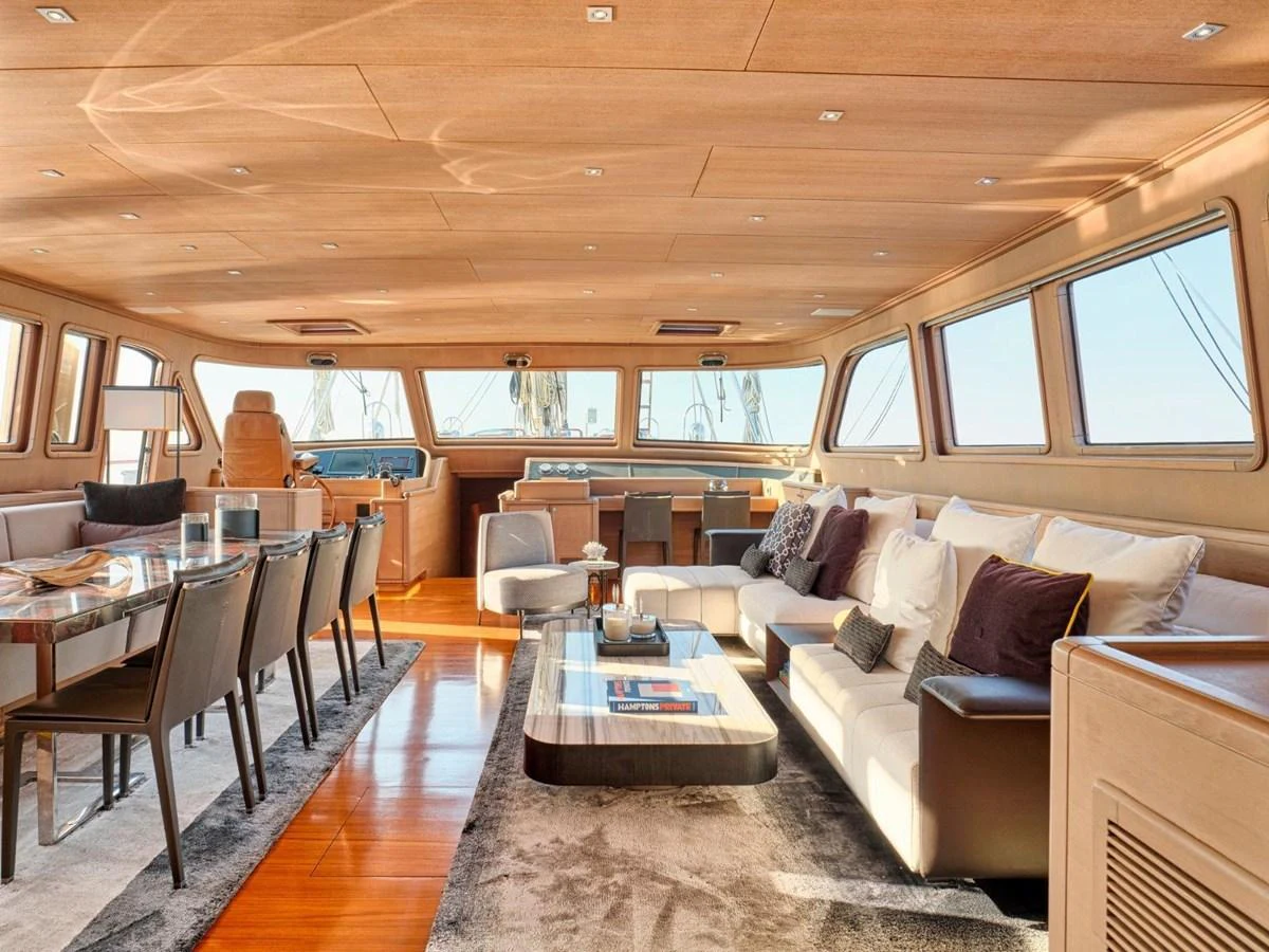 a living room with a couch and a table aboard PASA Yacht for Sale