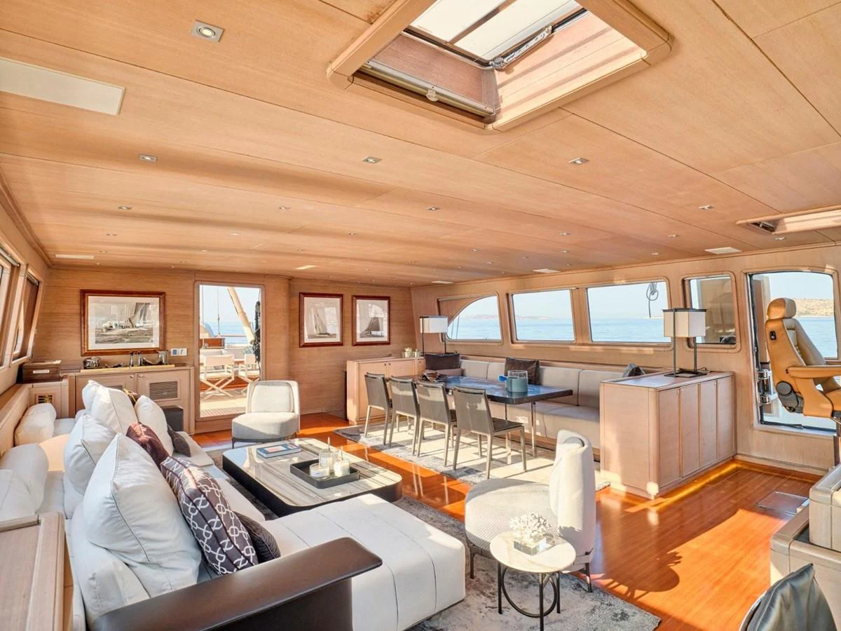 a living room with a couch and a tv aboard PASA Yacht for Sale