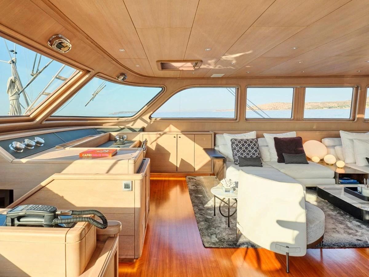 a room with a bed and a desk aboard PASA Yacht for Sale
