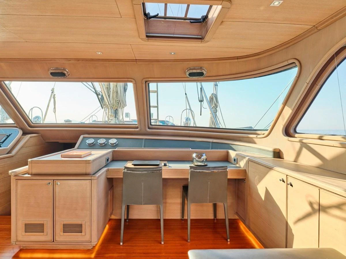 a room with a table and chairs aboard PASA Yacht for Sale