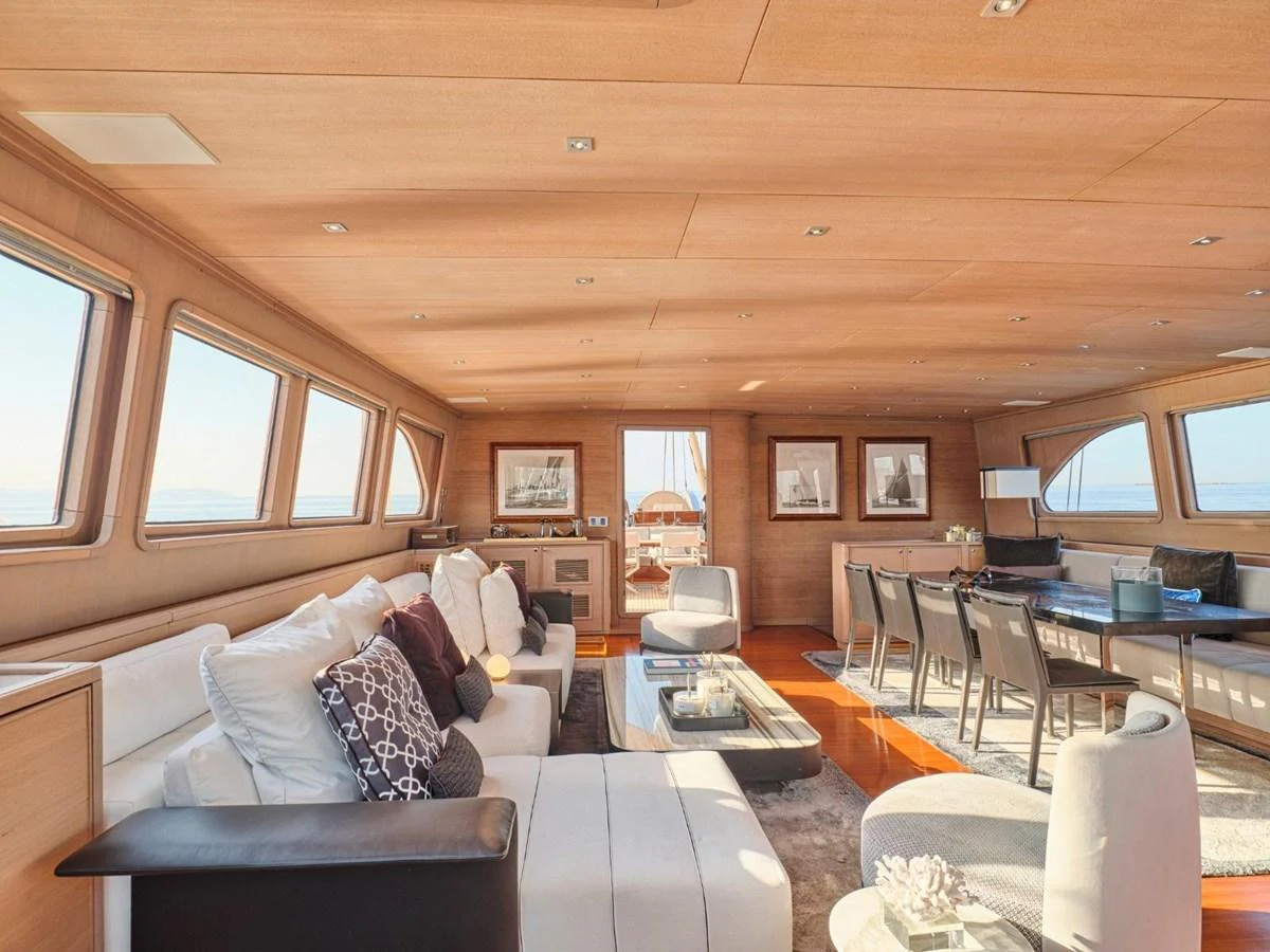 a living room with a couch and a tv aboard PASA Yacht for Sale