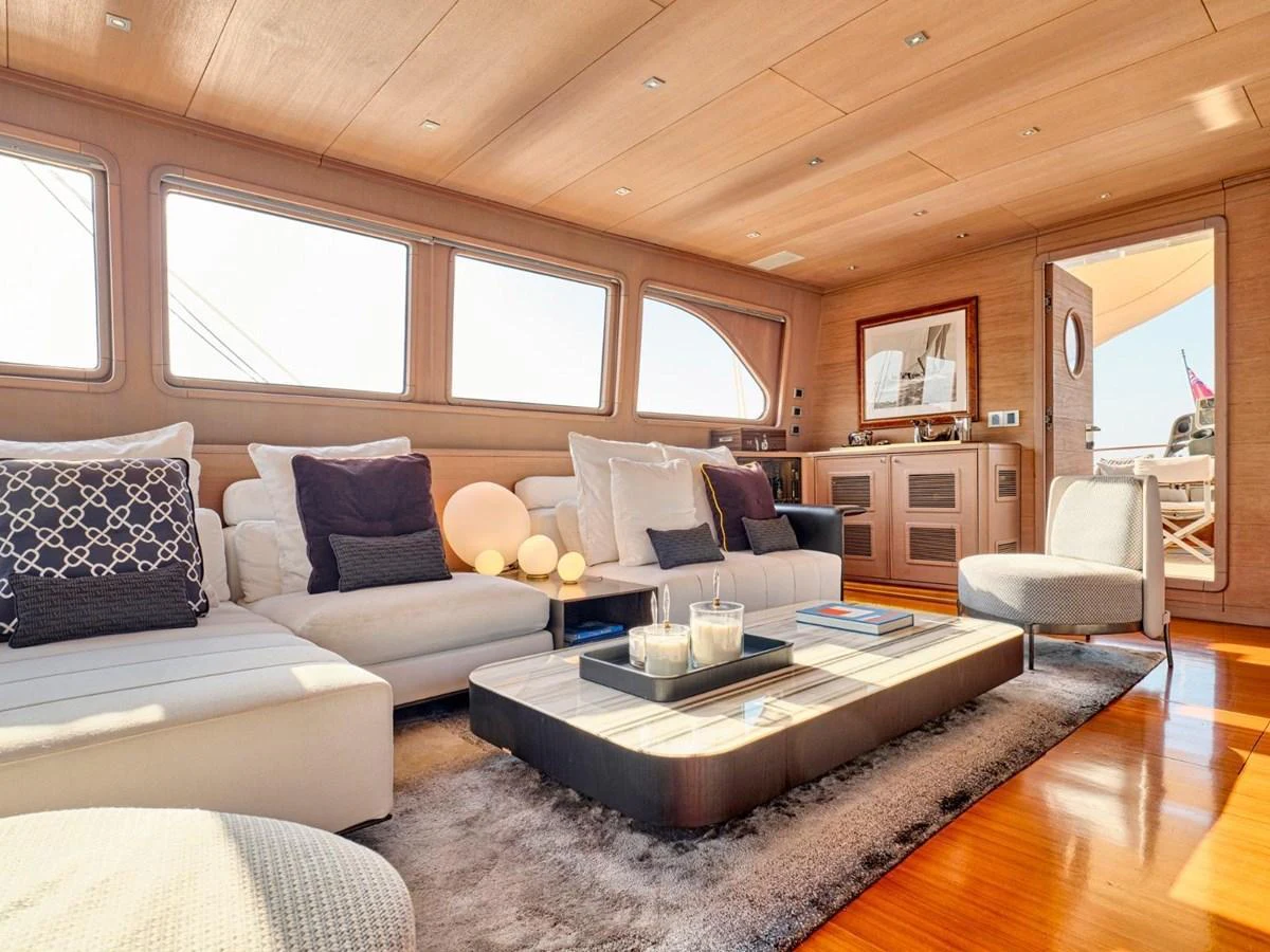 a living room with a couch and a coffee table aboard PASA Yacht for Sale