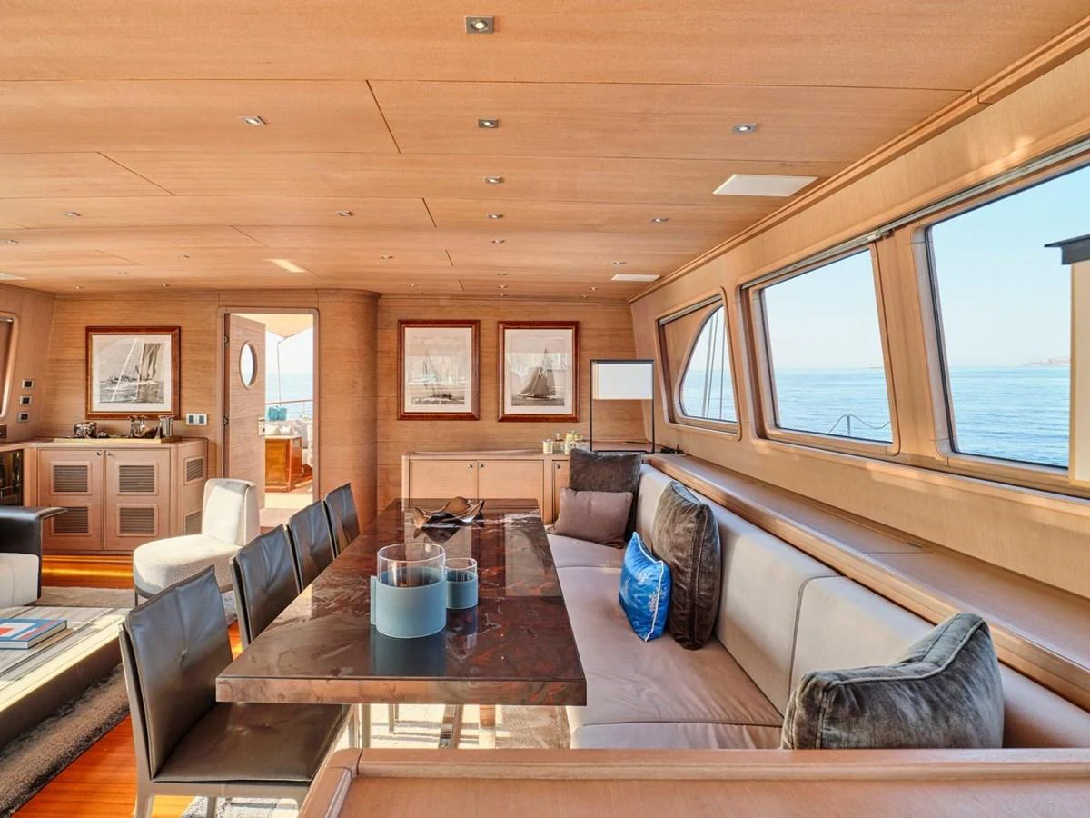 a living room with a large sofa aboard PASA Yacht for Sale