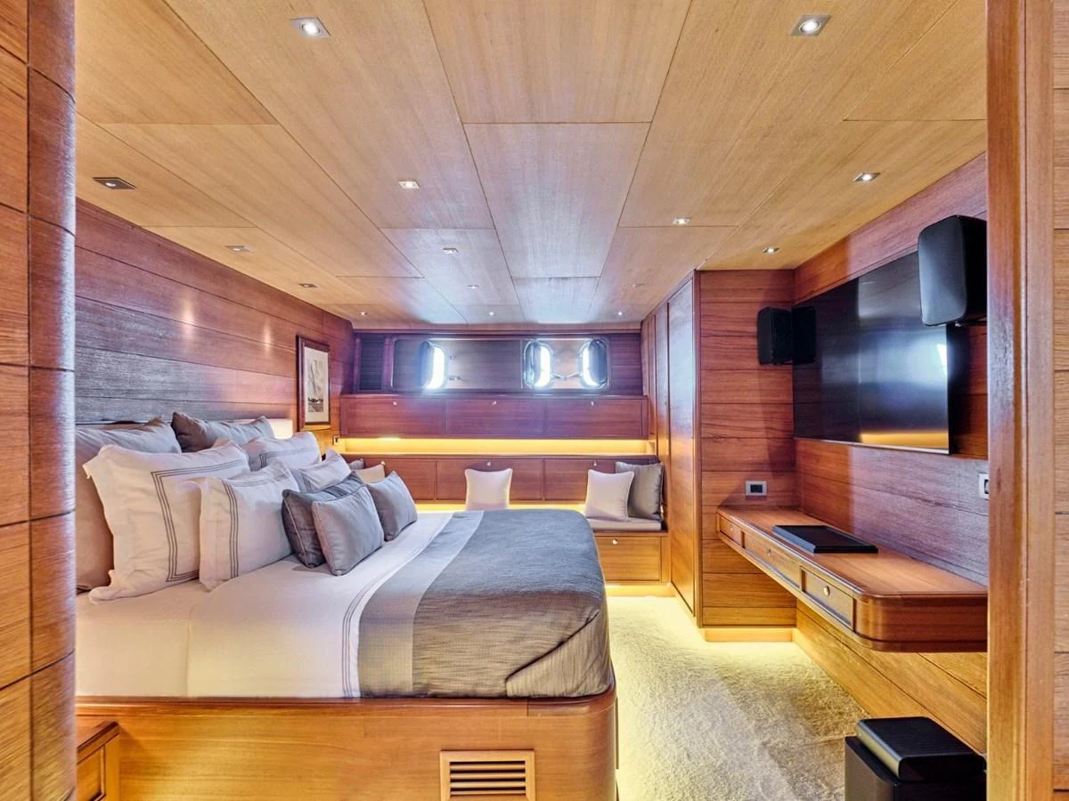 a room with a bed and a tv aboard PASA Yacht for Sale