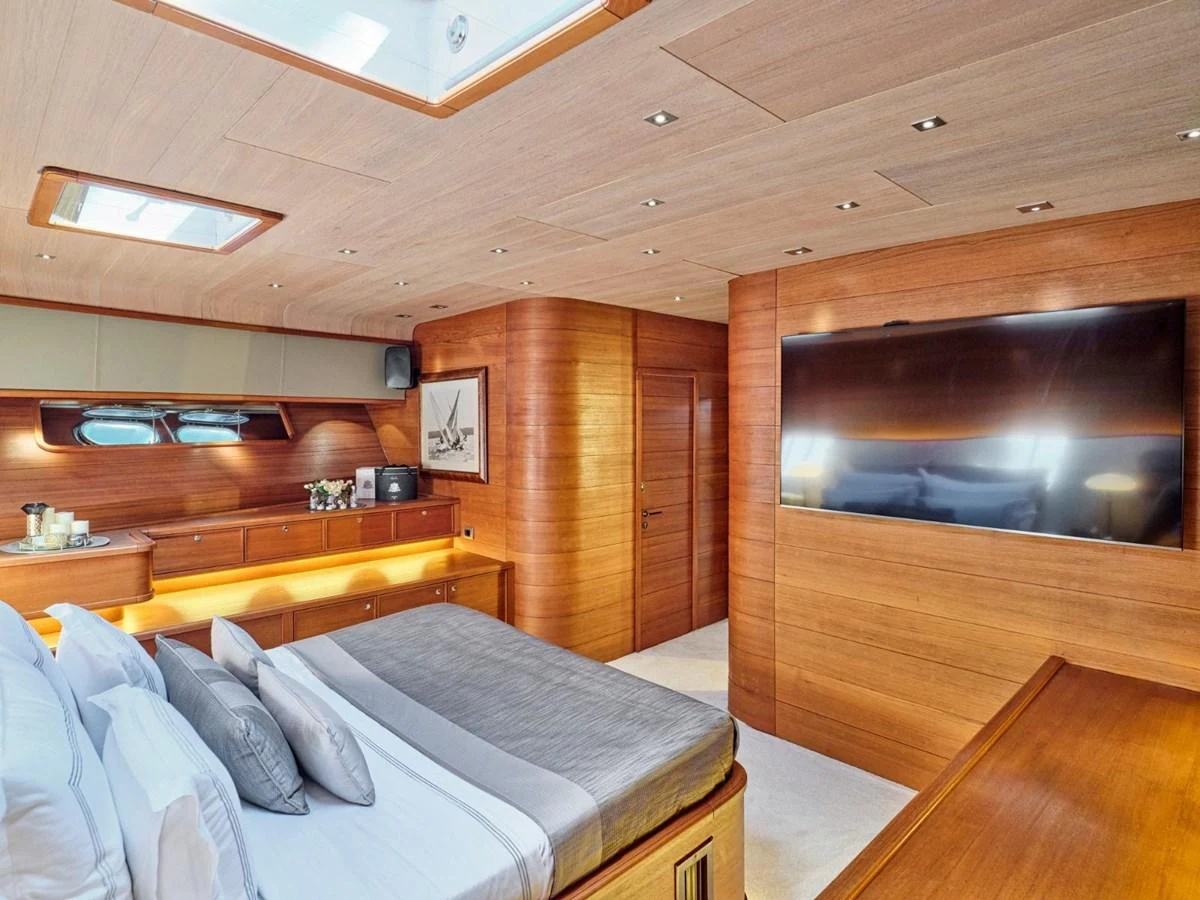 a room with a bed and a television aboard PASA Yacht for Sale