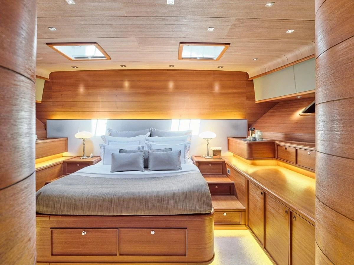 a room with a bed and a desk aboard PASA Yacht for Sale