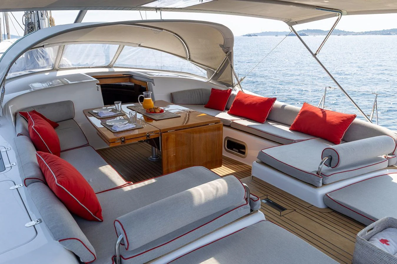 a boat with pillows and a table aboard SKIP'N BOU Yacht for Sale