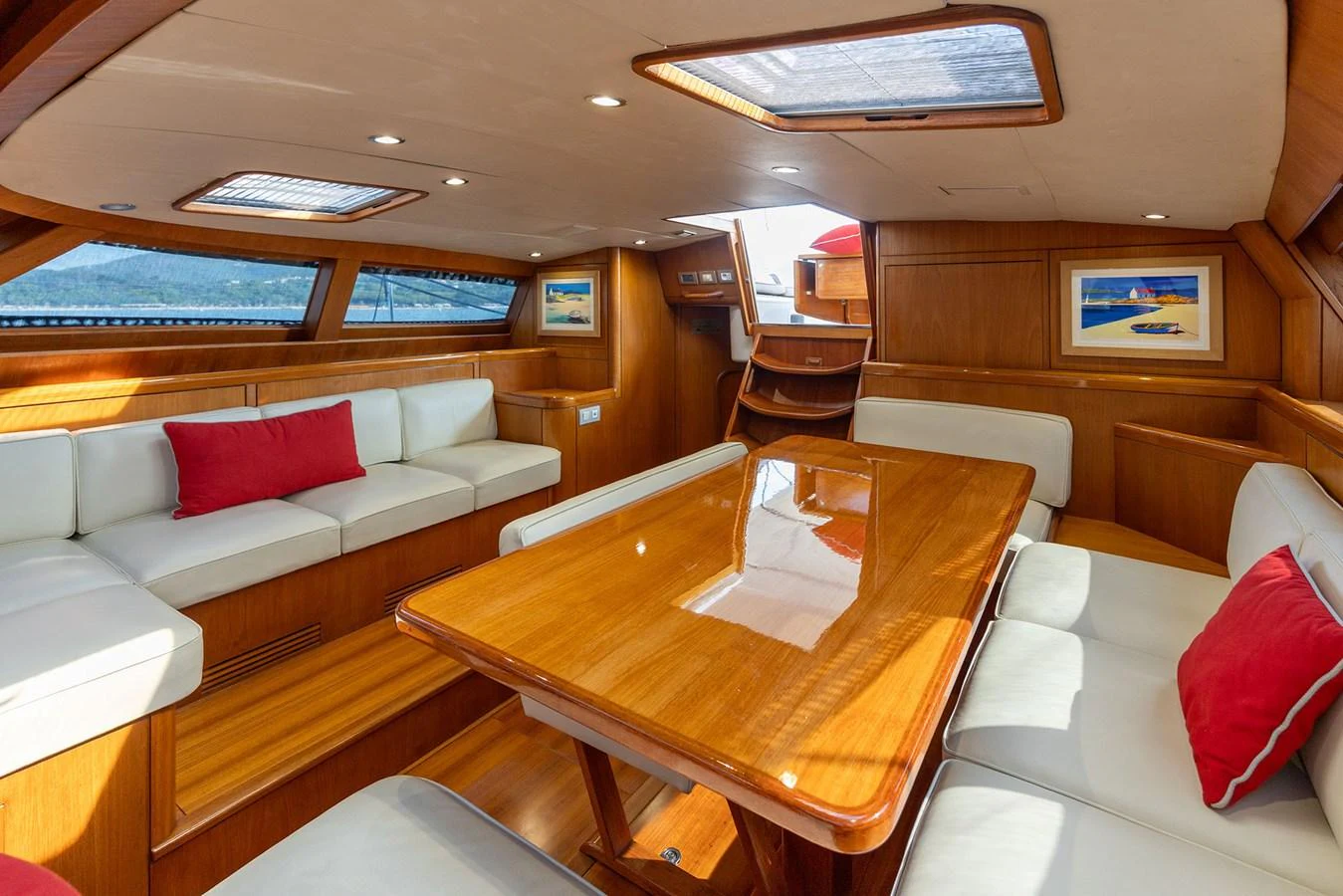 a room with a table and couches aboard SKIP'N BOU Yacht for Sale