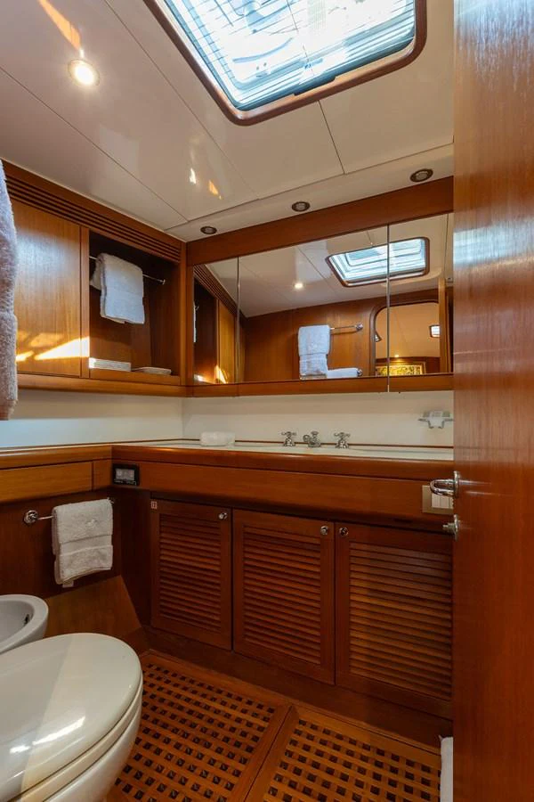 a bathroom with wooden cabinets aboard SKIP'N BOU Yacht for Sale