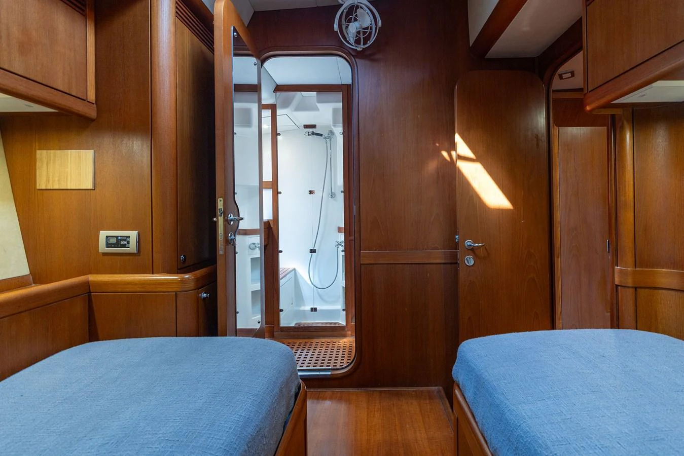 a bedroom with a bed and a mirror aboard SKIP'N BOU Yacht for Sale
