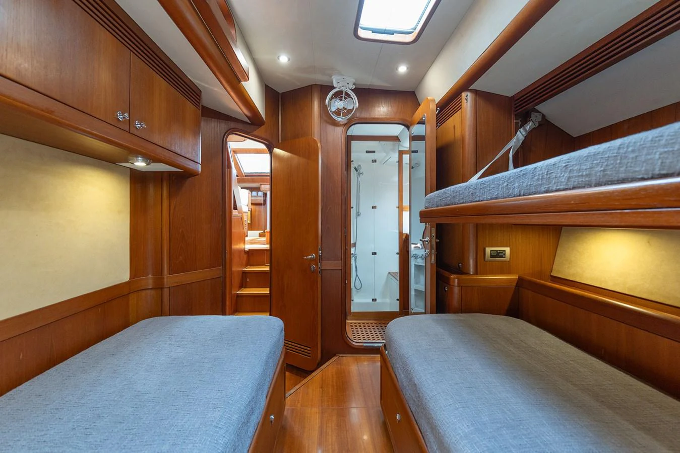 a room with wooden furniture aboard SKIP'N BOU Yacht for Sale