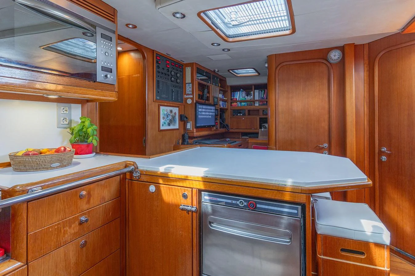 a kitchen with wooden cabinets aboard SKIP'N BOU Yacht for Sale