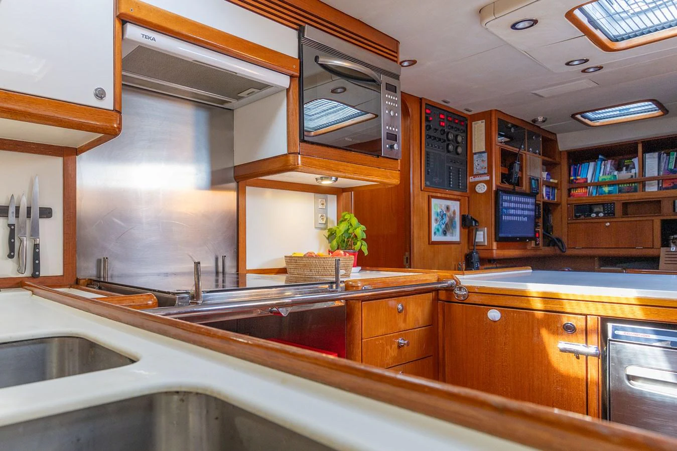 a kitchen with wooden cabinets aboard SKIP'N BOU Yacht for Sale
