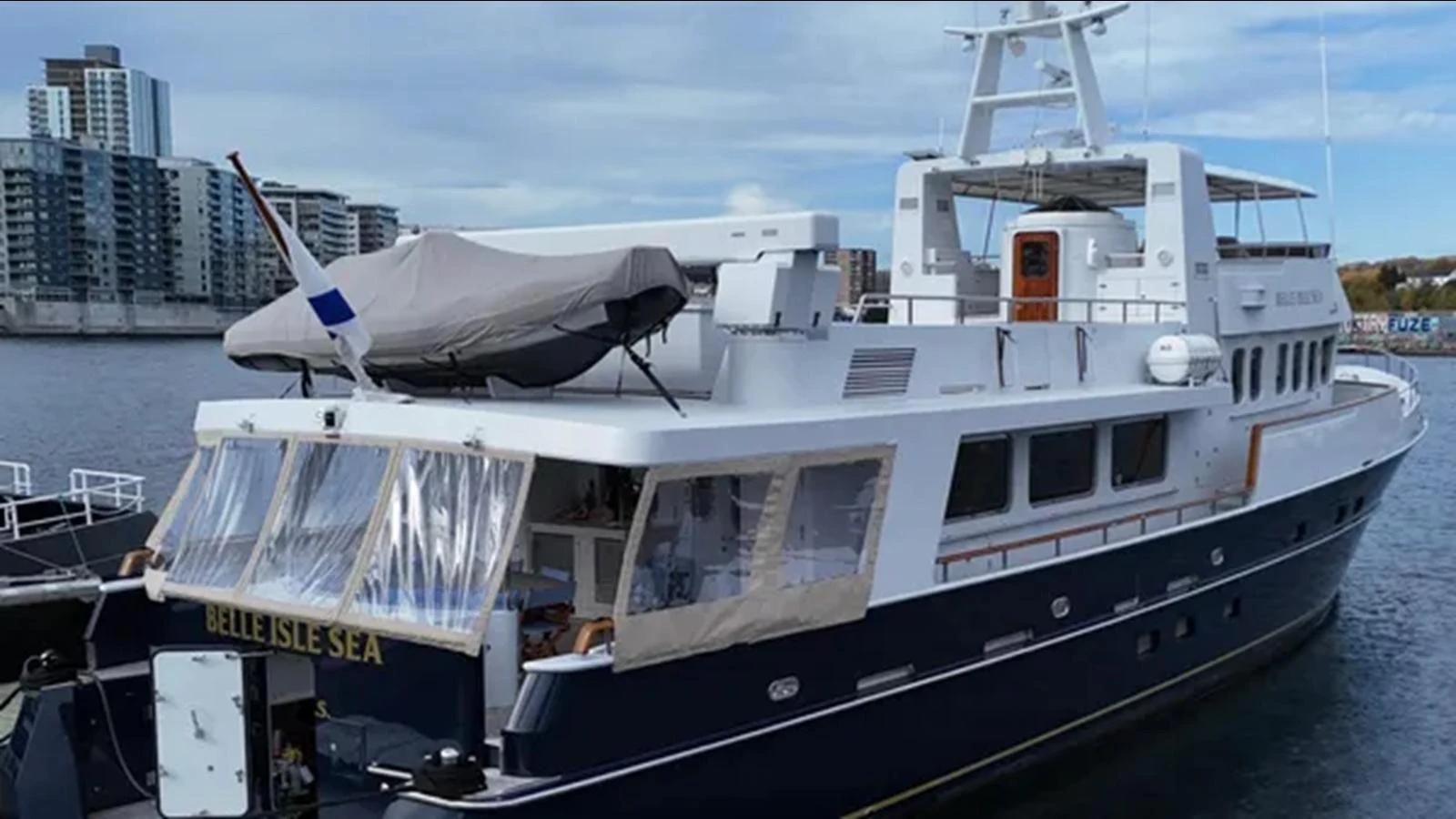 a large white boat in a harbor aboard BELLE ISLE SEA Yacht for Sale