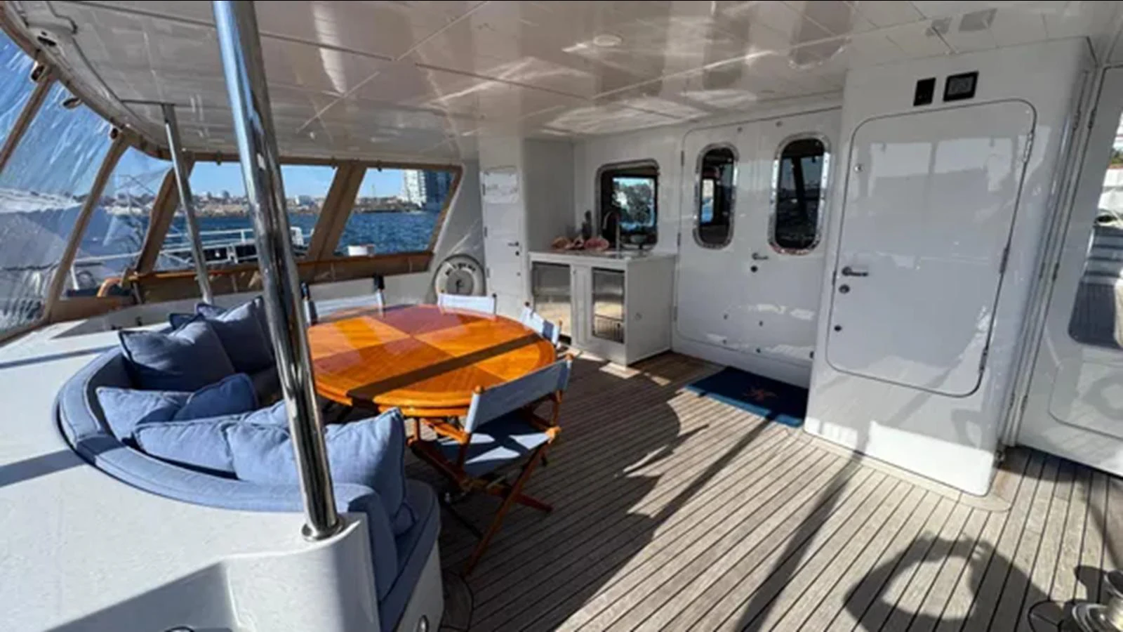a room with a bed and a large window aboard BELLE ISLE SEA Yacht for Sale
