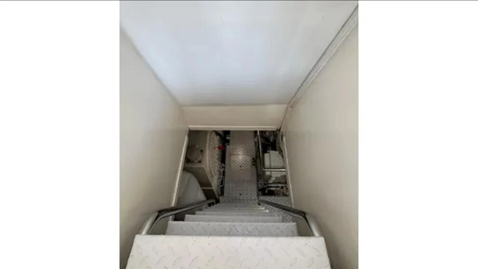 a staircase with a white wall aboard BELLE ISLE SEA Yacht for Sale