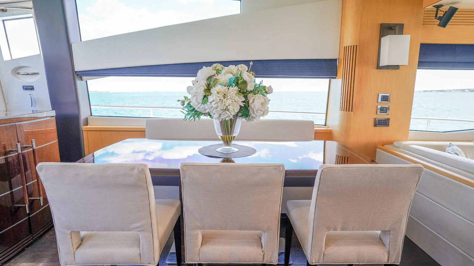 a dining table with white flowers aboard DADDY'S $ Yacht for Sale