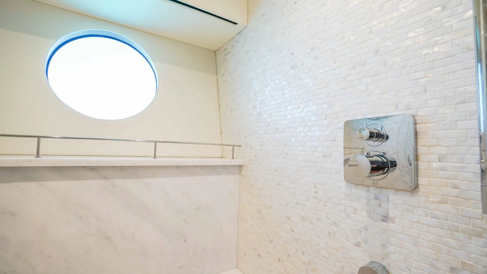 a round window on a white wall aboard DADDY'S $ Yacht for Sale