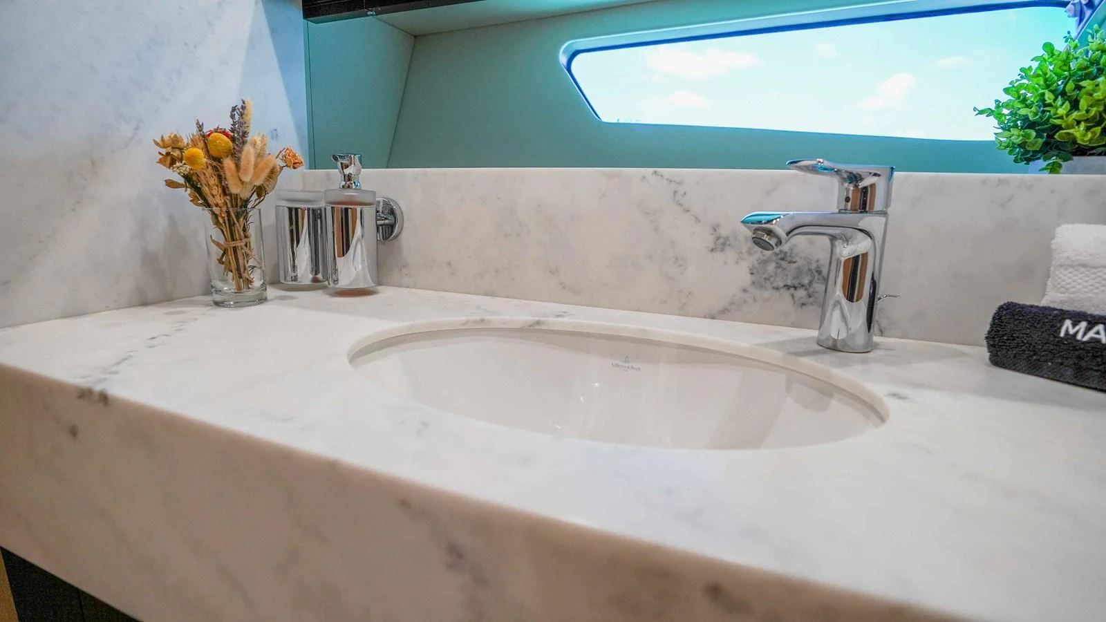 a bathtub with a flower vase and a sink aboard DADDY'S $ Yacht for Sale