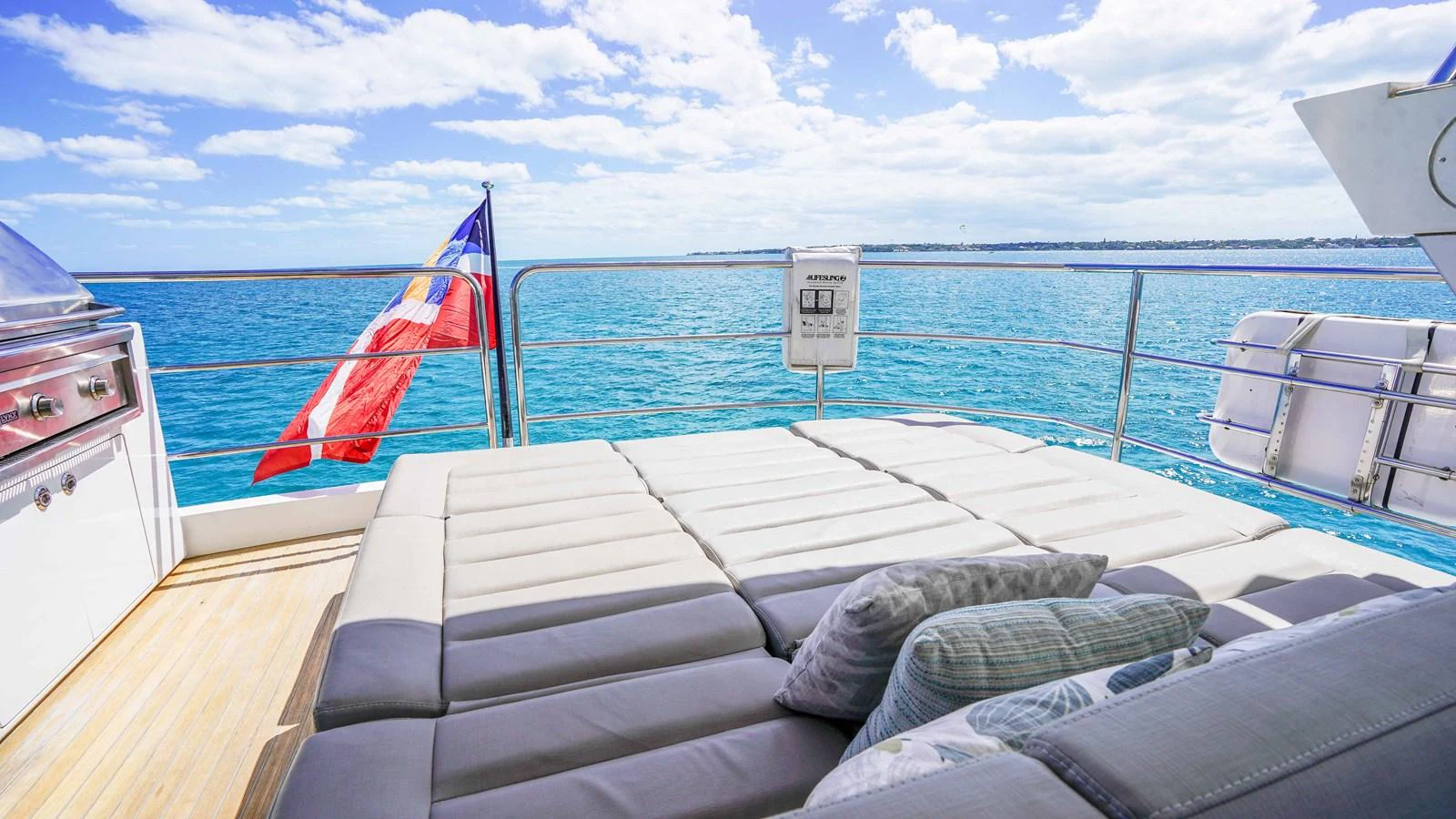 a boat with a flag on the deck aboard DADDY'S $ Yacht for Sale
