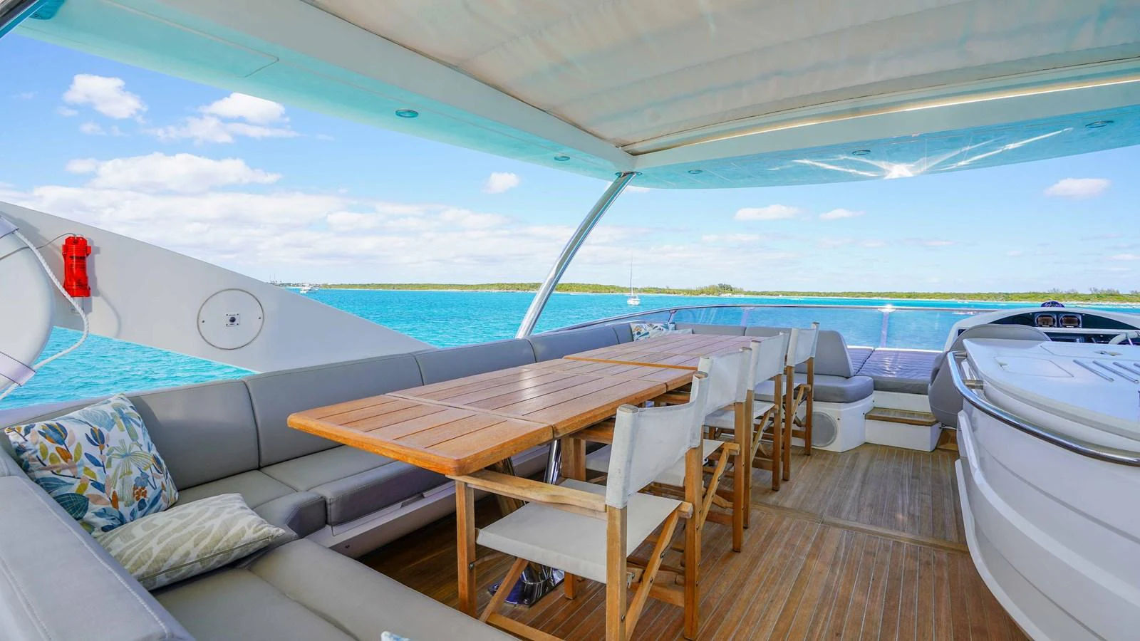 a deck with a table and chairs on it aboard DADDY'S $ Yacht for Sale