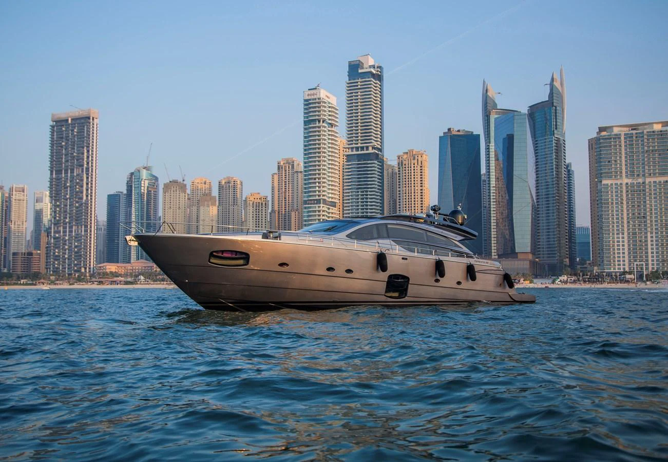 a boat in the water with a city in the background aboard STRAGA Yacht for Sale