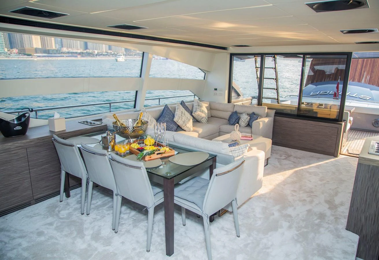 a living room with a table and chairs aboard STRAGA Yacht for Sale