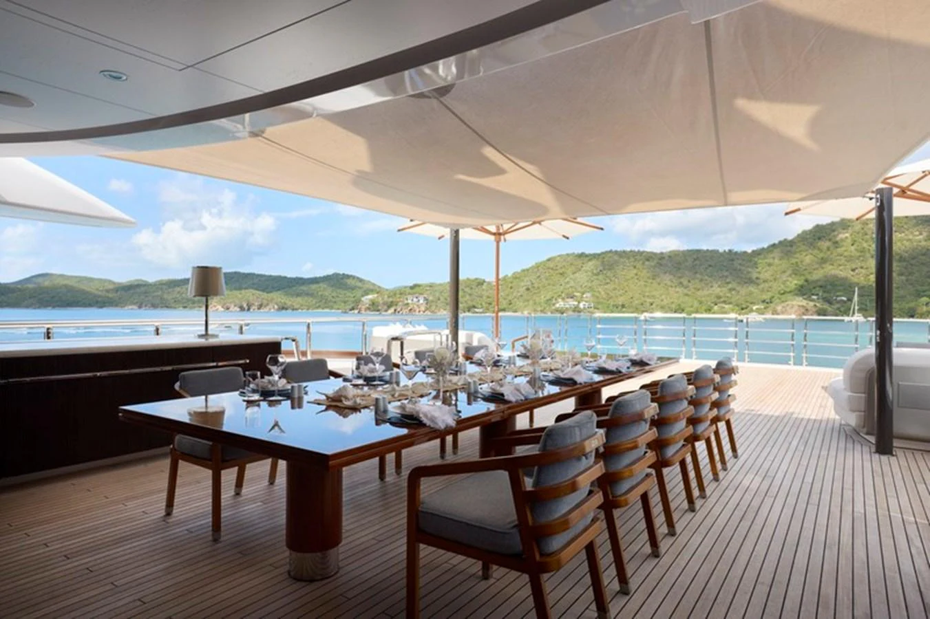 a table and chairs on a deck aboard VANISH Yacht for Sale