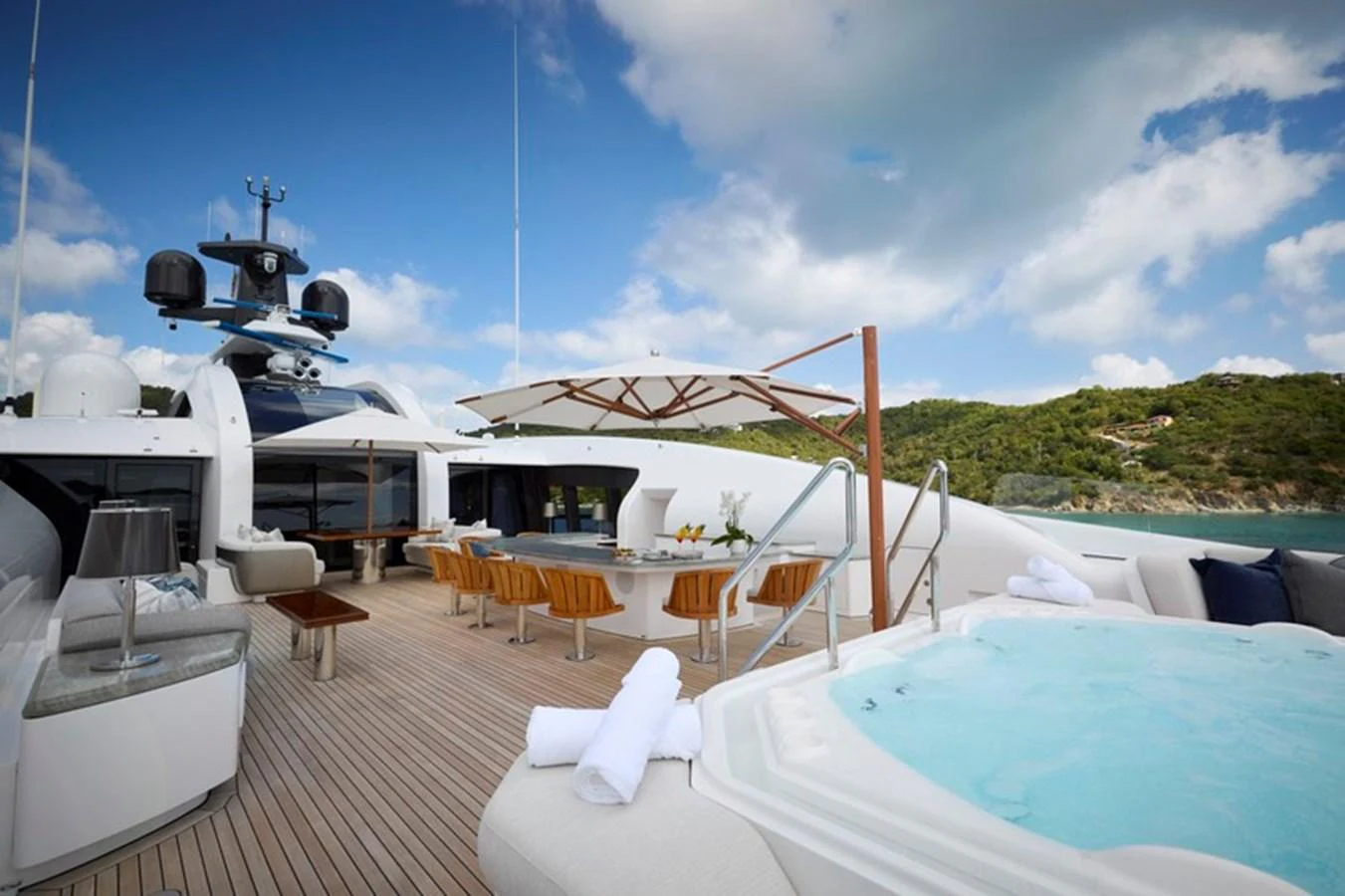a lounge area with a table and chairs on it aboard VANISH Yacht for Sale