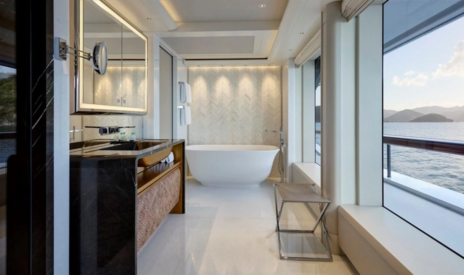 a bathroom with a tub sink and a window aboard VANISH Yacht for Sale