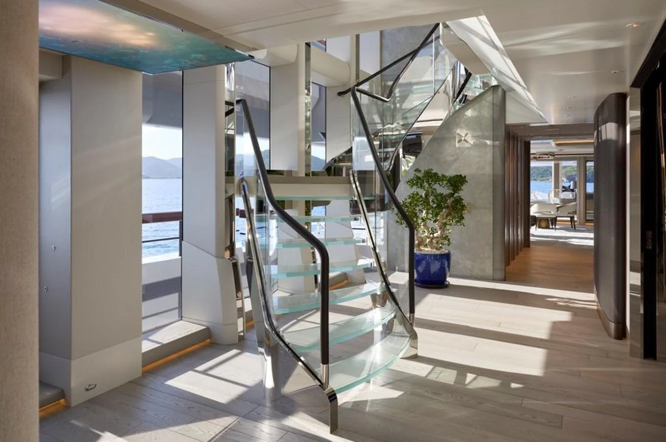 a glass staircase in a building aboard VANISH Yacht for Sale