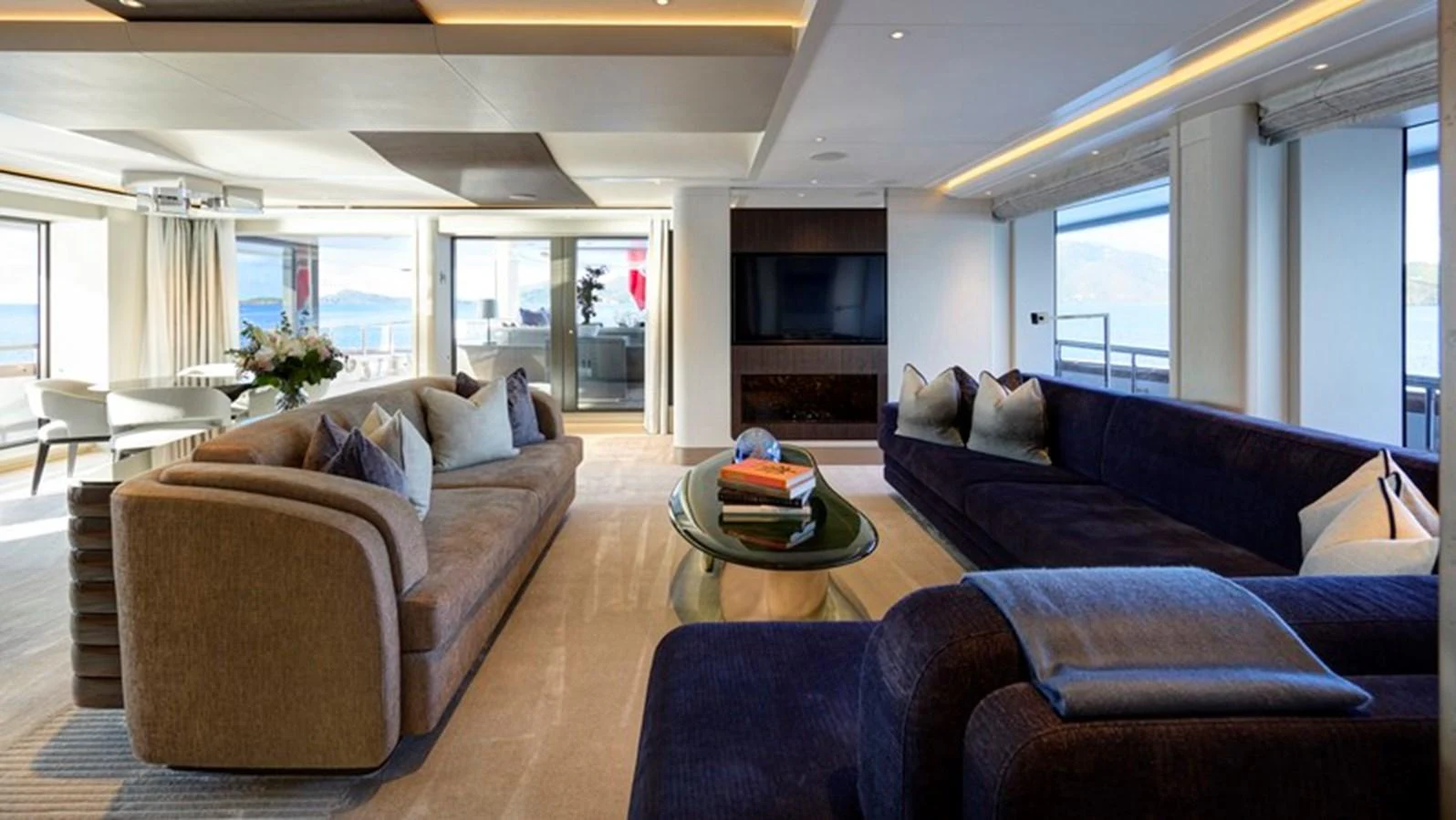 a living room with couches and a table aboard VANISH Yacht for Sale