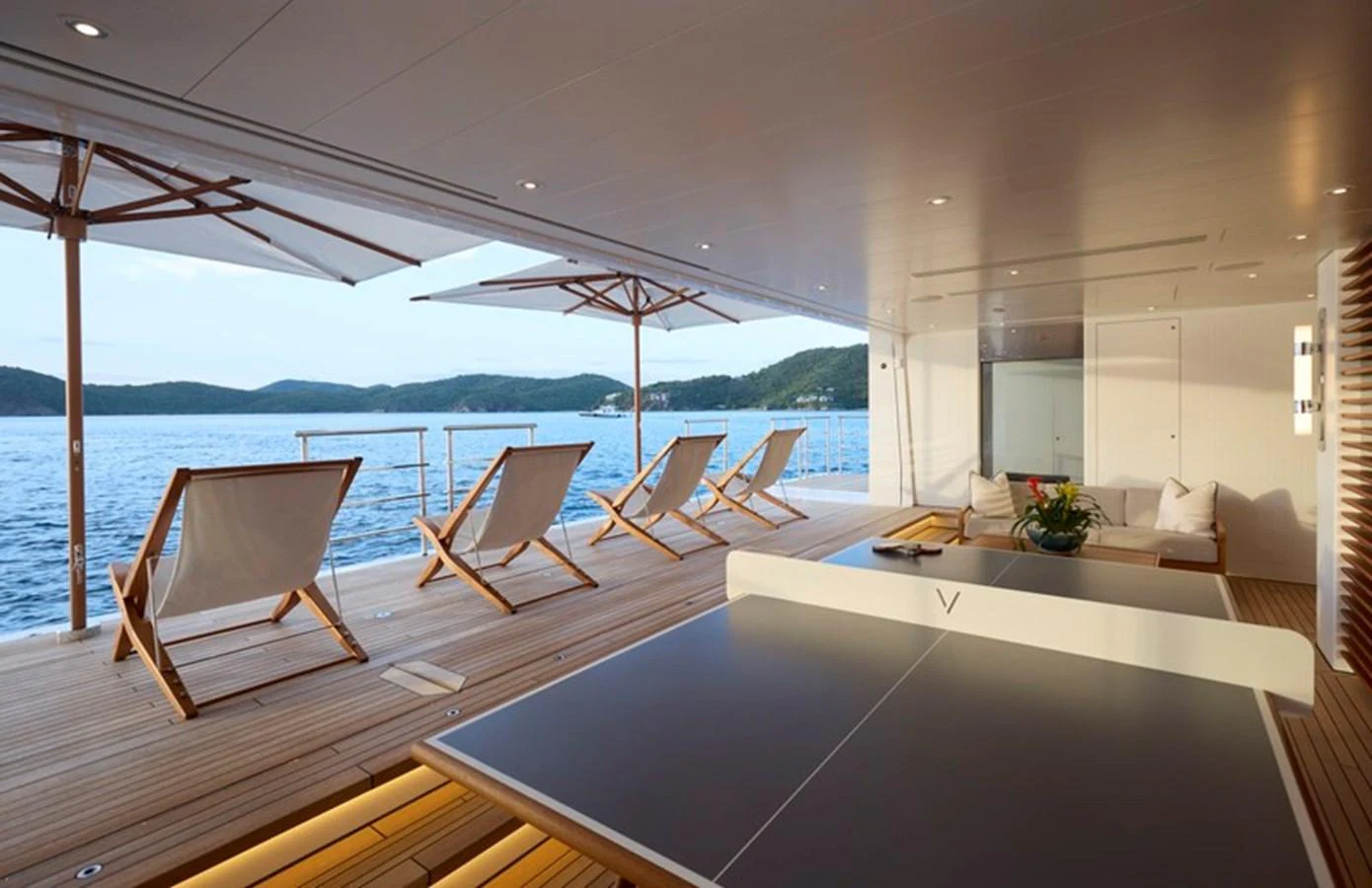 a room with a large table and chairs on a boat aboard VANISH Yacht for Sale