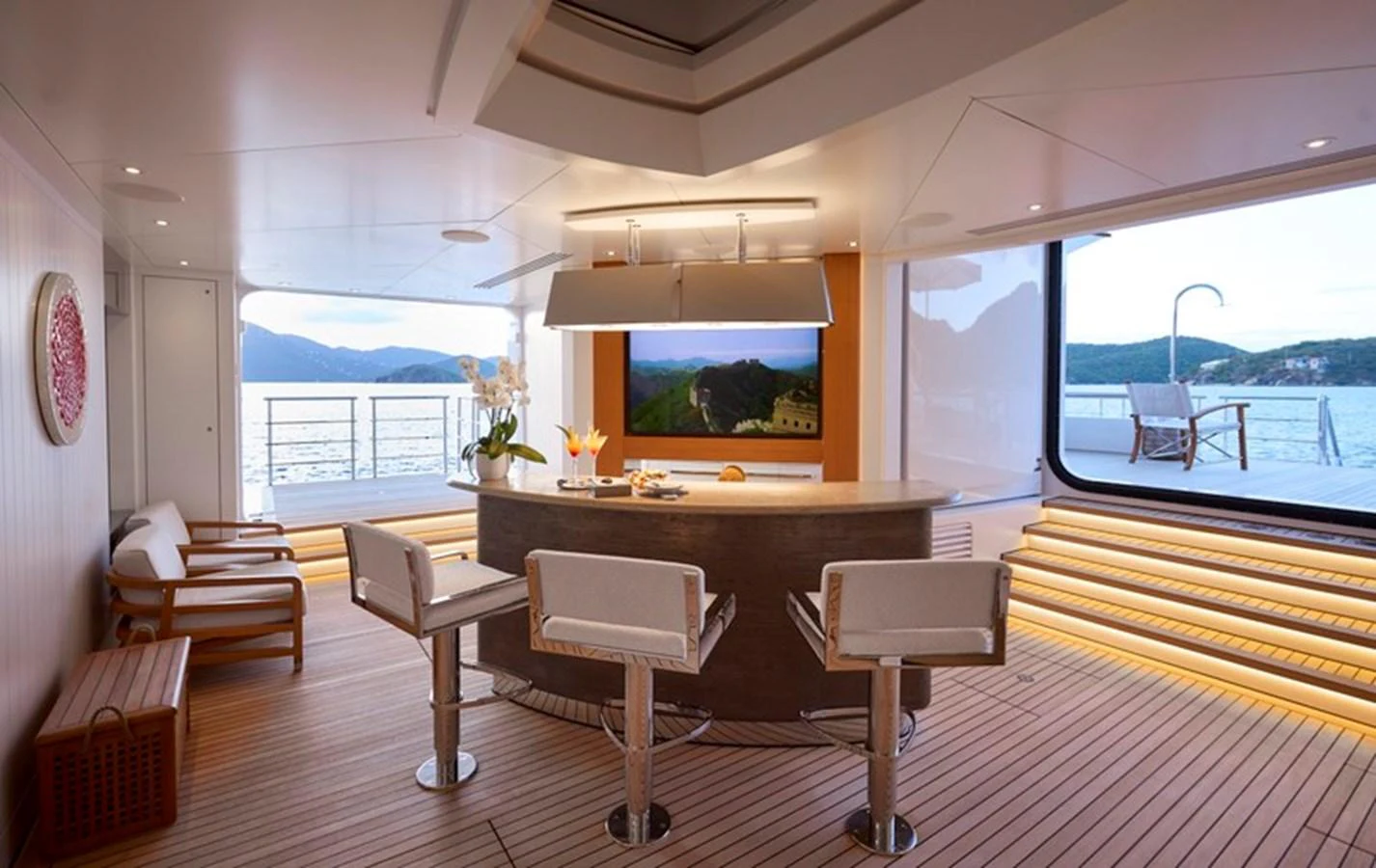 a room with a table chairs and a tv aboard VANISH Yacht for Sale