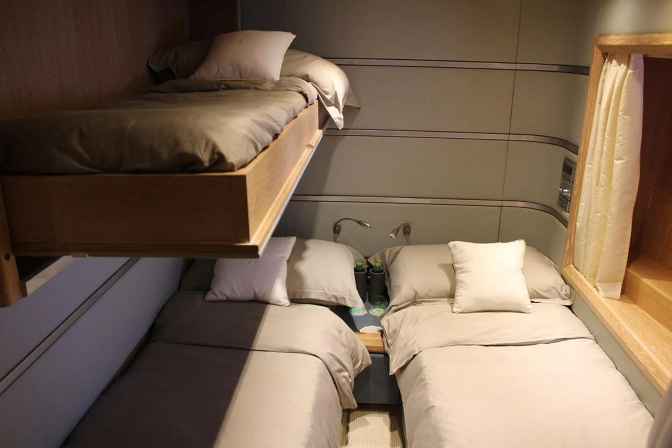 a room with beds and a wood bed aboard AZIMUT 98 LEONARDO Yacht for Sale
