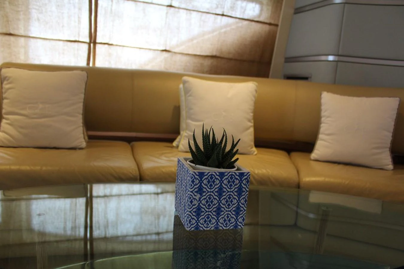 a couch with pillows and a plant aboard AZIMUT 98 LEONARDO Yacht for Sale