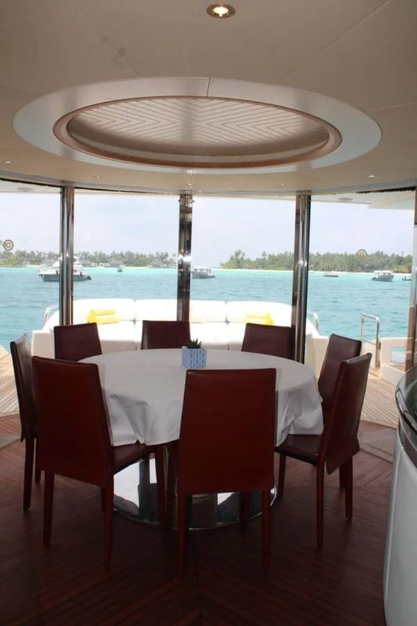 a table and chairs on a deck aboard AZIMUT 98 LEONARDO Yacht for Sale