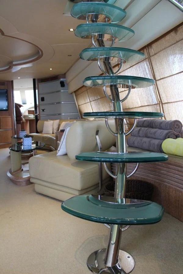 a living room with a glass table aboard AZIMUT 98 LEONARDO Yacht for Sale